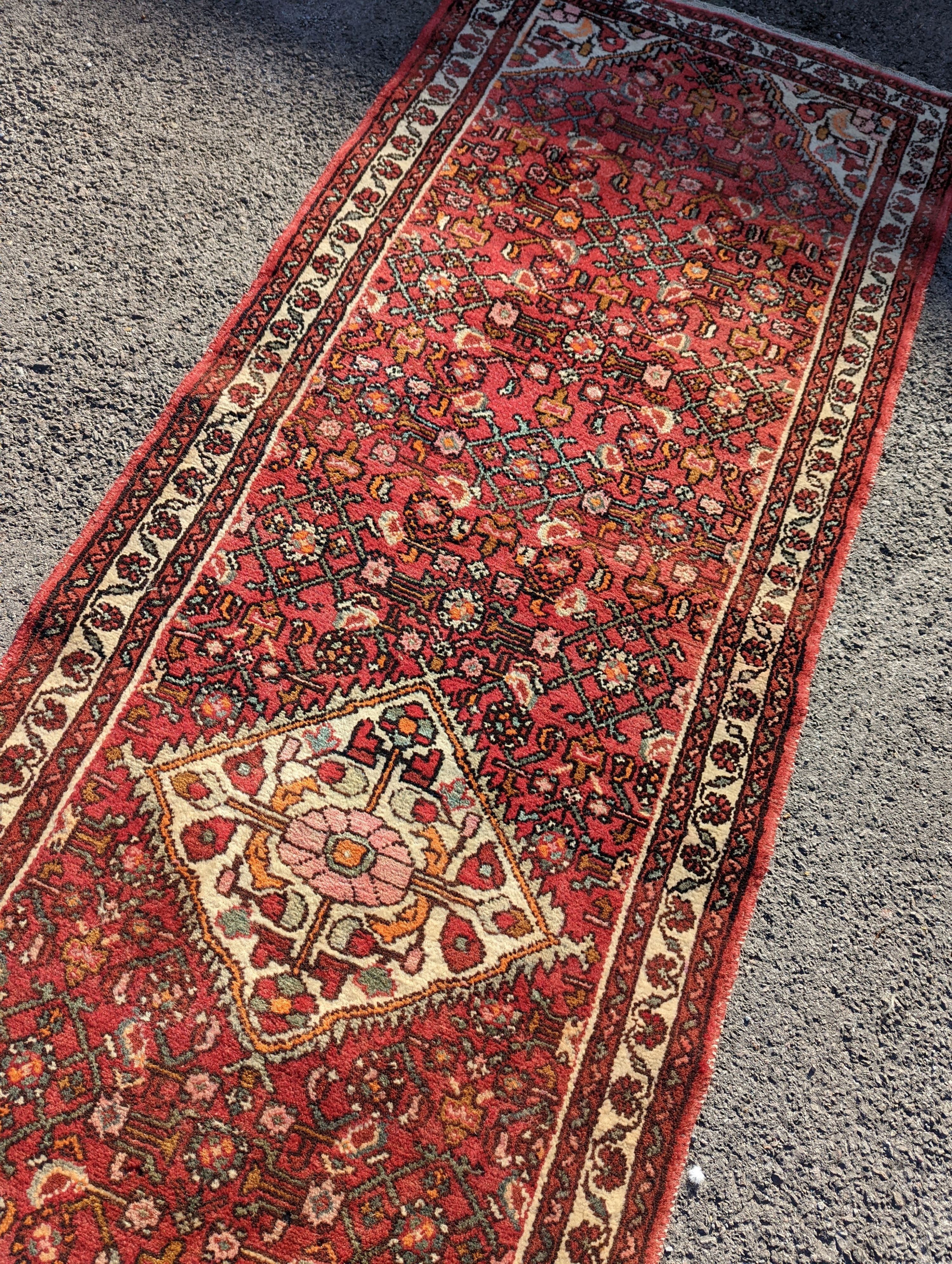 A North West Persian red ground runner, 290 x 82cm